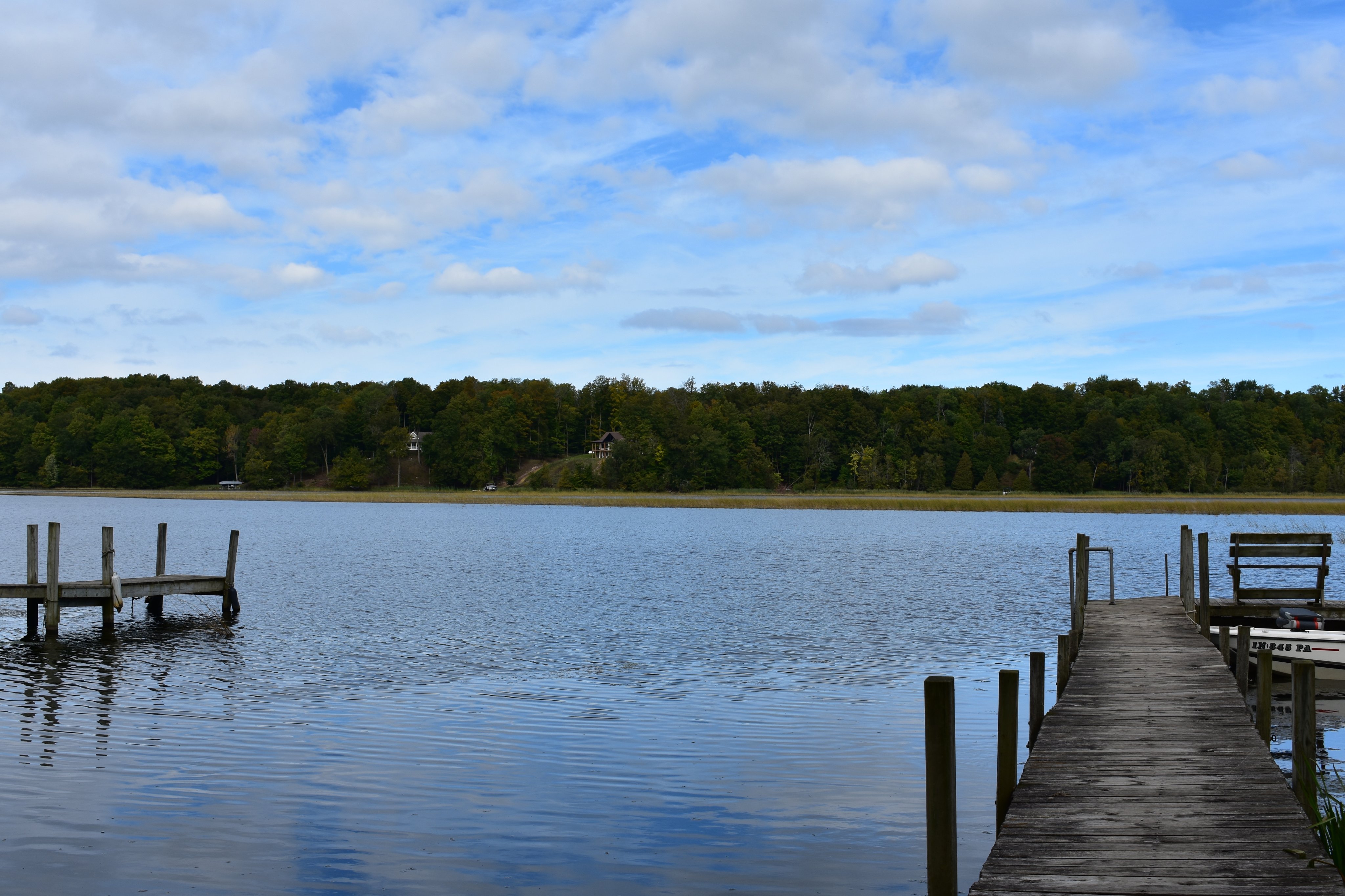 Wooden dock reaching into calm Upper Hamlin Lake