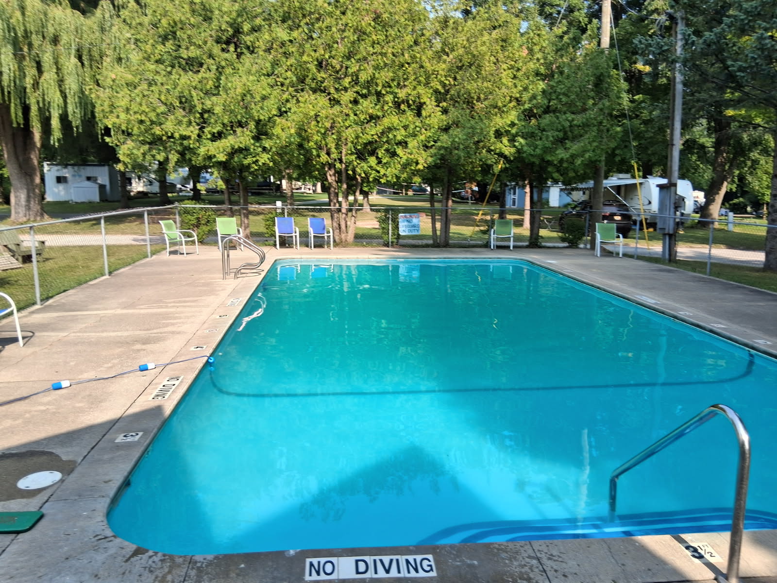 Lakeview Campsite swimming pool with lounge chairs along the deck